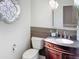 Well-lit powder room with a decorative window and mosaic tile backsplash at 5601 E Monte Cristo Ave, Scottsdale, AZ 85254