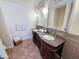 Bathroom with dual sinks, decorative mirrors, dark wood cabinets and tiled floors at 5601 E Monte Cristo Ave, Scottsdale, AZ 85254