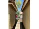Exterior view of courtyard gate with black iron and stucco walls with tile roof overhead at 5601 E Monte Cristo Ave, Scottsdale, AZ 85254