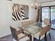 Dining room features a glass-top table, woven chairs, and a modern chandelier at 5601 E Monte Cristo Ave, Scottsdale, AZ 85254