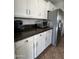 Kitchen features stainless steel refrigerator, white cabinets, and dark countertops at 5601 E Monte Cristo Ave, Scottsdale, AZ 85254