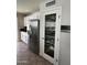 Spacious kitchen with white cabinets, stainless steel refrigerator, and glass door pantry at 5601 E Monte Cristo Ave, Scottsdale, AZ 85254