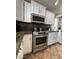 Updated kitchen with stainless steel appliances, white cabinets, and sleek granite countertops at 5601 E Monte Cristo Ave, Scottsdale, AZ 85254
