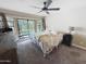 Bright main bedroom with a ceiling fan, large windows, and a sliding glass door at 5601 E Monte Cristo Ave, Scottsdale, AZ 85254