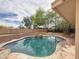 Backyard pool surrounded by desert landscaping, with rock features and shade trees at 5601 E Monte Cristo Ave, Scottsdale, AZ 85254