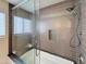 Bathroom shower featuring neutral tile, niche, and a glass door at 5601 E Monte Cristo Ave, Scottsdale, AZ 85254