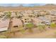 Wide aerial shot showcases a residential neighborhood, highlighting the homes and desert landscape at 608 E Pasaro Dr, Phoenix, AZ 85085