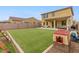 Large, turfed backyard with covered patio and block wall fence at 608 E Pasaro Dr, Phoenix, AZ 85085