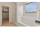 Bathroom showcasing a soaking tub, glass shower, and a scenic window view at 608 E Pasaro Dr, Phoenix, AZ 85085