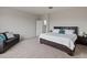Bedroom with carpeted floors, a sofa, and a queen bed with white linens at 608 E Pasaro Dr, Phoenix, AZ 85085