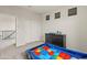 Bedroom with carpeted floors, race car bed, three small windows, and a dresser at 608 E Pasaro Dr, Phoenix, AZ 85085