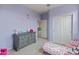 bedroom featuring light purple walls and matching sliding door closet at 608 E Pasaro Dr, Phoenix, AZ 85085