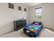 Bedroom with carpeted floors, race car bed, one window, and a dresser at 608 E Pasaro Dr, Phoenix, AZ 85085