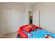 bedroom with a race car bed and a view of the laundry room entrance, a fun and functional space at 608 E Pasaro Dr, Phoenix, AZ 85085