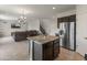 Open-concept kitchen with an island, stainless steel refrigerator, and comfortable seating, ideal for entertaining at 608 E Pasaro Dr, Phoenix, AZ 85085