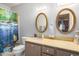 Bathroom featuring a vanity with and mirrors, with an ocean themed shower curtain at 6118 N 12Th Pl # 2, Phoenix, AZ 85014