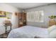 Bedroom with a corner book shelf, window with blinds, and bright, decorative plants at 6118 N 12Th Pl # 2, Phoenix, AZ 85014