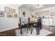 Bright dining area featuring hardwood floors, glass table, four chairs, white trim, and easy kitchen access at 6118 N 12Th Pl # 2, Phoenix, AZ 85014