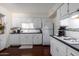 Bright kitchen featuring white cabinetry, updated appliances, and dark countertops at 6118 N 12Th Pl # 2, Phoenix, AZ 85014