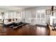 Bright living room with hardwood floors, white sofa, modern window shutters, and mirrored wall at 6118 N 12Th Pl # 2, Phoenix, AZ 85014