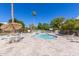 A community pool area featuring a sunshade, tables, lounge chairs and desert landscaping at 6118 N 12Th Pl # 2, Phoenix, AZ 85014