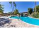 Beautiful community pool surrounded by lounge chairs, lush landscaping, and clear blue skies at 6118 N 12Th Pl # 2, Phoenix, AZ 85014