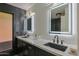 Contemporary bathroom featuring dual sinks, lighted mirrors, and a sleek, tiled shower with glass door at 6278 N 31St Way, Phoenix, AZ 85016