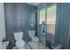 Modern bathroom showcasing a tiled shower with glass door and rain shower head, complemented by a toilet at 6278 N 31St Way, Phoenix, AZ 85016