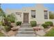 The front entrance features a wooden shutter door and neatly trimmed landscaping leading up the slate-tiled stairs at 6278 N 31St Way, Phoenix, AZ 85016