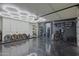 View of a finished garage featuring an organized workout area, epoxy floors, and honeycomb ceiling lights at 6278 N 31St Way, Phoenix, AZ 85016