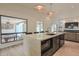 Bright kitchen island with bar seating, modern appliances, and open access to the living room at 6278 N 31St Way, Phoenix, AZ 85016
