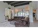 Bright, open-concept living room featuring sliding glass doors, a large brown sofa, and hardwood floors at 6278 N 31St Way, Phoenix, AZ 85016