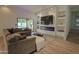 Open-concept living area featuring sliding glass doors, natural light, and a comfortable sectional sofa at 6278 N 31St Way, Phoenix, AZ 85016