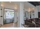 Bright, open-concept living room featuring sliding glass doors, a large brown sofa, and hardwood floors at 6278 N 31St Way, Phoenix, AZ 85016
