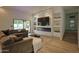 Bright living room with custom built-ins, a modern fireplace, and seamless indoor-outdoor living at 6278 N 31St Way, Phoenix, AZ 85016