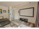 Bright living room with a large media screen, minimalist decor, and cozy seating area at 6278 N 31St Way, Phoenix, AZ 85016
