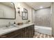 Well-lit bathroom with dual sinks, granite countertops, and a shower-tub combo at 8361 E Via De Viva --, Scottsdale, AZ 85258