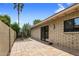 Exterior patio features terracotta tiles, brick facade, desert landscaping, and entry to the home at 8361 E Via De Viva --, Scottsdale, AZ 85258