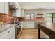Well-lit kitchen with stainless steel appliances, white cabinets, decorative tile backsplash, and island at 8361 E Via De Viva --, Scottsdale, AZ 85258
