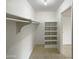 Walk-in closet with built-in shelving and closet rod that provides ample storage space at 930 S Acapulco Ln # D, Tempe, AZ 85281