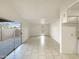 Open concept living area with neutral tile floors, leading to a sliding glass door and bright interior at 930 S Acapulco Ln # D, Tempe, AZ 85281