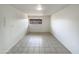 Bright living room featuring neutral tile floors, natural light, and a fresh coat of white paint at 930 S Acapulco Ln # D, Tempe, AZ 85281