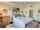 Comfortable bedroom with natural light, showcasing tasteful decor, and hardwood floors with an ensuite at 10015 E Mountain View Rd # 2012, Scottsdale, AZ 85258
