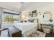 Bright bedroom with a large window, plush bedding, and curated artwork creating a serene atmosphere at 10015 E Mountain View Rd # 2012, Scottsdale, AZ 85258