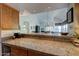 Kitchen bar top with view to dining room and living room areas at 10015 E Mountain View Rd # 2012, Scottsdale, AZ 85258