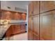 The kitchen features light wood cabinets, granite countertops and tile floors at 10015 E Mountain View Rd # 2012, Scottsdale, AZ 85258
