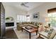 Bright living room with a cozy fireplace, plush seating, and lots of natural light at 10015 E Mountain View Rd # 2012, Scottsdale, AZ 85258