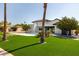 Landscaped backyard with a sparkling pool, lush turf, and palm trees perfect for entertaining at 10620 N 84Th St, Scottsdale, AZ 85260