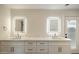 Bright bathroom featuring dual sinks with large illuminated mirrors at 10620 N 84Th St, Scottsdale, AZ 85260