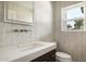 Stylish powder room featuring a modern vanity with marble countertop and brushed gold faucet at 10620 N 84Th St, Scottsdale, AZ 85260